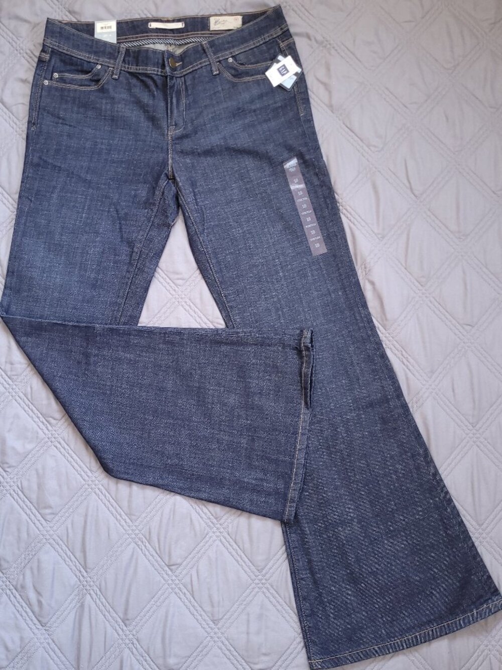 New Gap jeans-low rise, fitted thigh, and wide bottom opening in dark rinse.